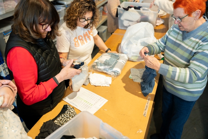 Women folding clothing 