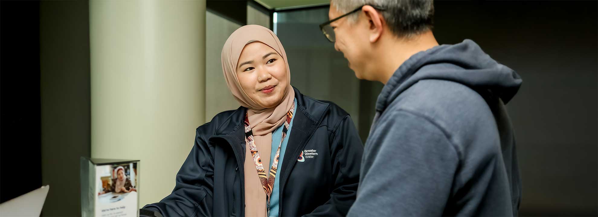A Greater Western Water Customer Service Officer talking to a customer.