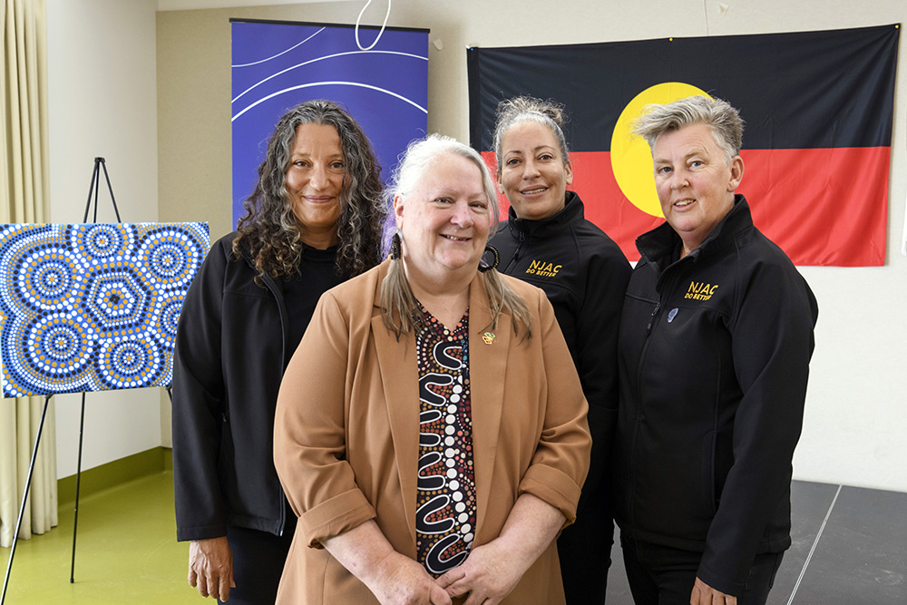 Kym Monohan (cenre) with members from the NJAC team