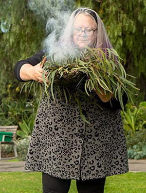 Kym performing a smoking ceremony in Footscray in 2023 