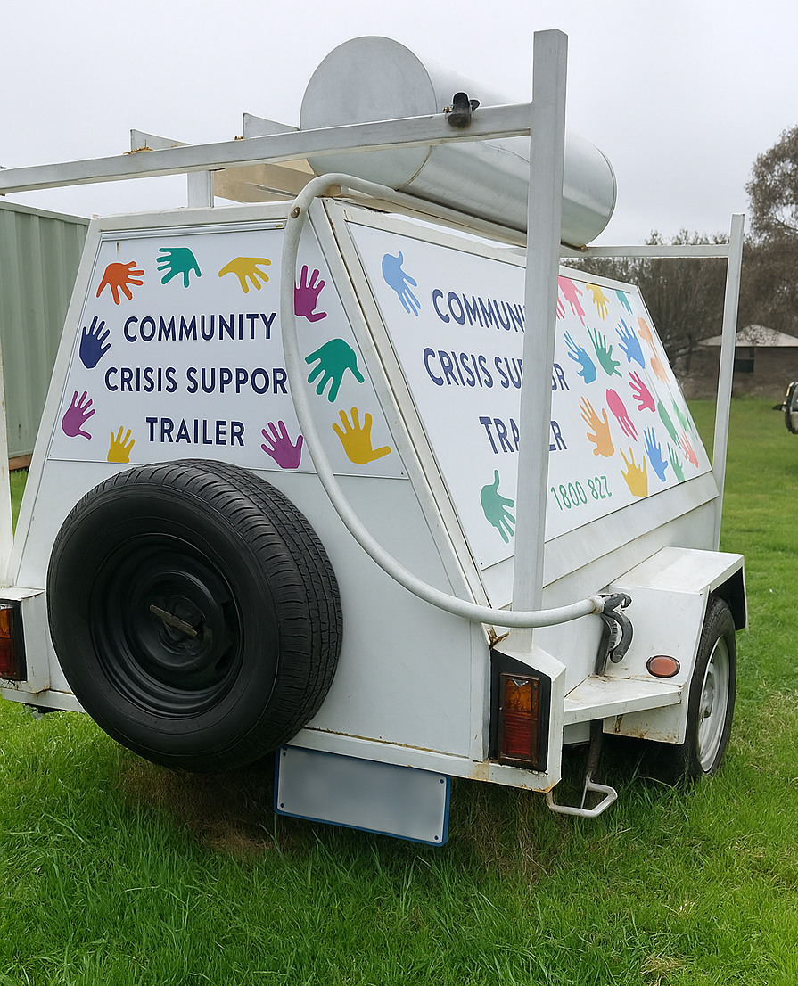 The Romsey Neighborhood House Community Crisis Support Trailer on green grass.