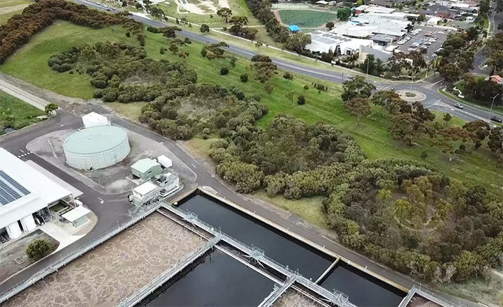 Altona Recycled Water Plant, showing the water storage containers surrounded by green tress and bushes.