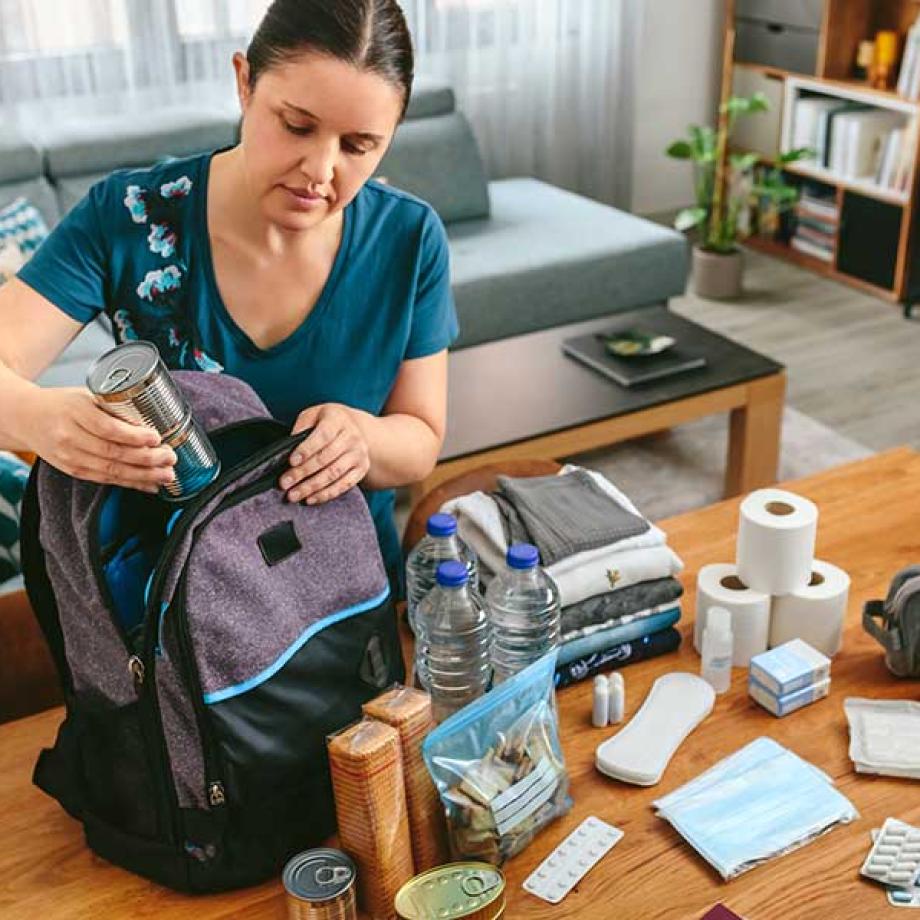 A person packing a Fire Ready Kit with items to be used to stay safe in case of a bushfire