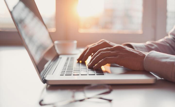 A person's hands using a computer