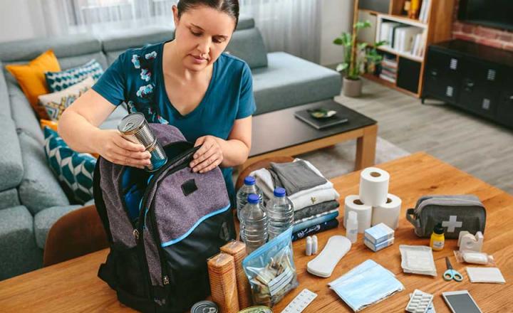 A person packing a Fire Ready Kit with items to be used to stay safe in case of a bushfire