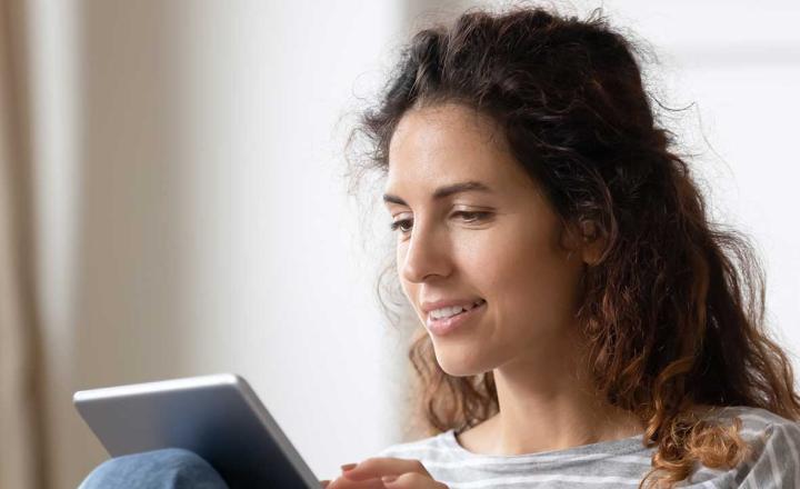 A person looking at a tablet computer.