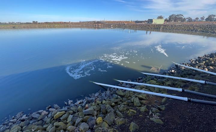 A lagoon at the Bacchus Marsh recycled water plant with pipes producing bubbles