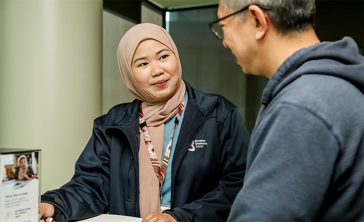 A Greater Western Water Customer Service Officer talking to a customer.