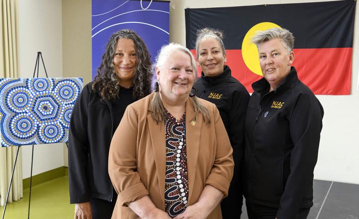 Kym Monohan (cenre) with members from the NJAC team