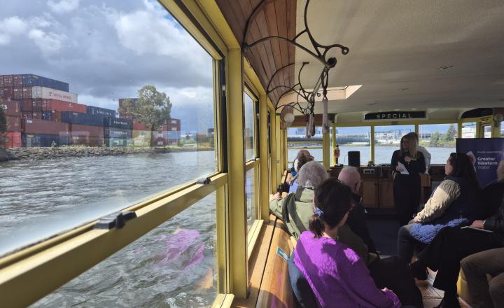 A view out the window of a boat to some shipping containers 