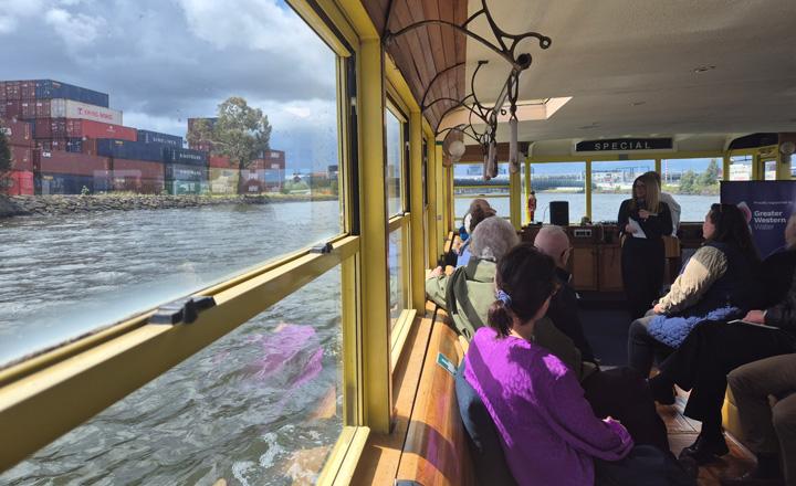 A view out the window of a boat to some shipping containers 