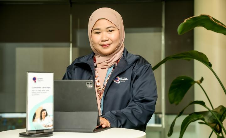 GWW Customer Service officer standing behind a computer at a Customer Care Day