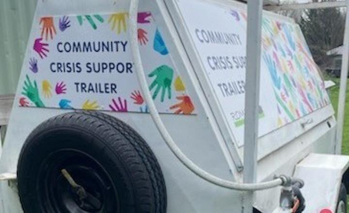 Romsey Neighborhood House Community Crisis Support Trailer on green grass.
