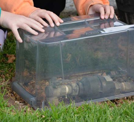 A clear plastic container is placed over the water meter to help prevent it from freezing during cold weather.