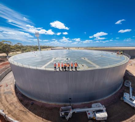 A group of GWW workers standing atop the new water tank.