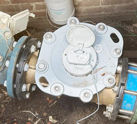 A digital monitoring device attached to a main water meter