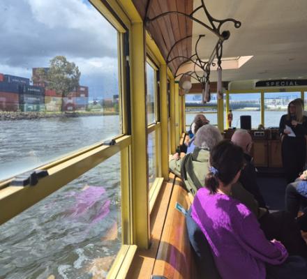 A view out the window of a boat to some shipping containers 